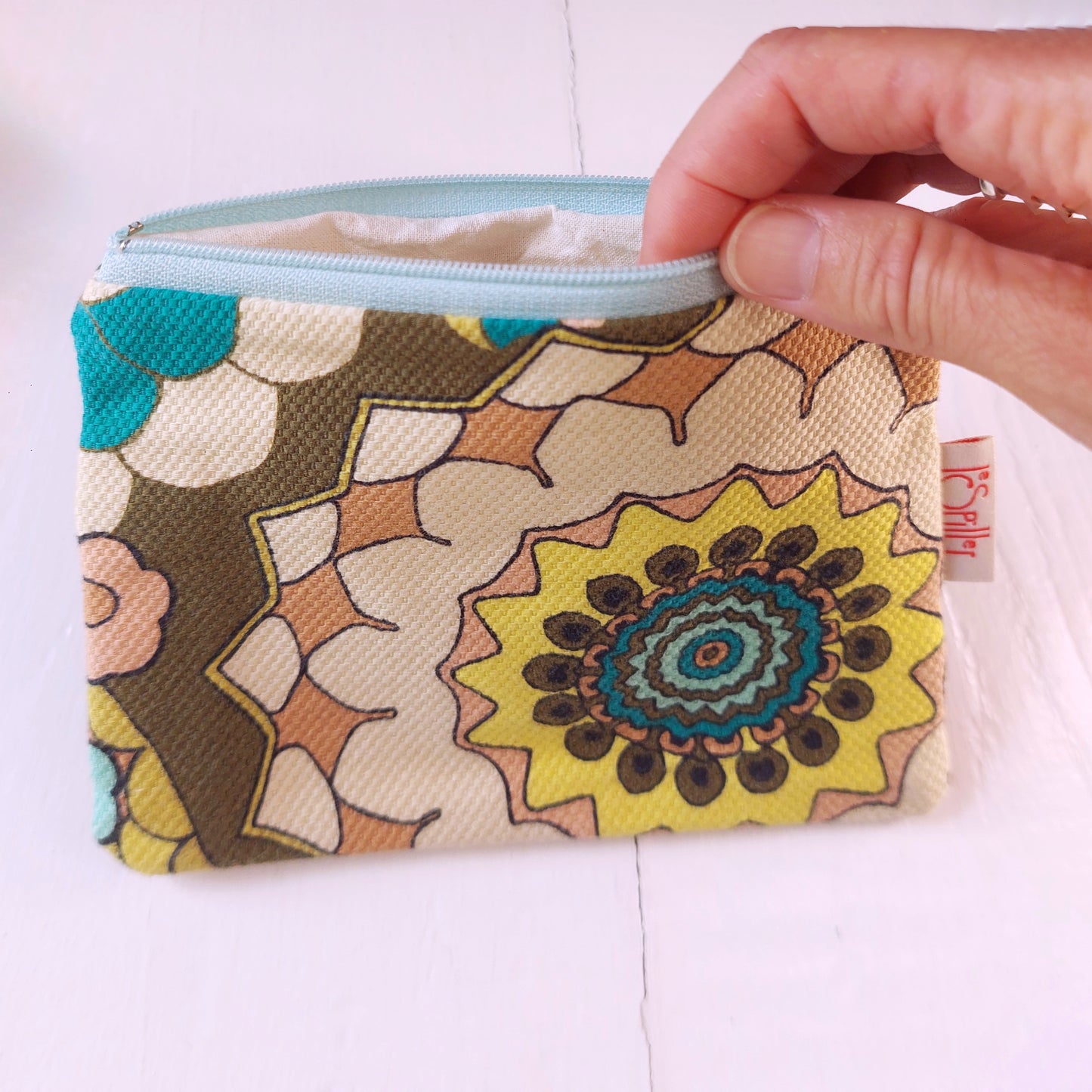 Pochette in cotone con decorazione floreale geometrica con colori pastello e foderata.
